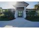 Stunning entrance to the clubhouse, featuring meticulously kept landscaping and a modern architectural design at 14081 Heritage Landing Blvd # 232, Punta Gorda, FL 33955