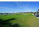 Driving range with golfers practicing their swing, overlooking the lake at 14081 Heritage Landing Blvd # 232, Punta Gorda, FL 33955