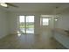 Bright living room with access to a balcony overlooking a serene lake at 14081 Heritage Landing Blvd # 232, Punta Gorda, FL 33955