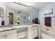 Bright bathroom featuring double vanity, marble countertops, and access to a shower at 1452 Wassail Ln, Punta Gorda, FL 33983