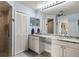 Well-lit bathroom with double sinks, a shower, and ample cabinet storage at 1452 Wassail Ln, Punta Gorda, FL 33983