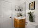 Cozy bathroom featuring a single vanity, large mirror, and tasteful decor at 1452 Wassail Ln, Punta Gorda, FL 33983