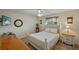 Cozy bedroom with neutral walls, a decorative ceiling fan, and ample natural light at 1452 Wassail Ln, Punta Gorda, FL 33983