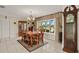 Elegant dining room with decorative chandelier, bay window, grandfather clock, and a large table with seating at 1452 Wassail Ln, Punta Gorda, FL 33983