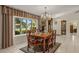 Dining room featuring large window, chandelier and a grandfather clock at 1452 Wassail Ln, Punta Gorda, FL 33983