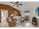Comfortable living room with neutral tones, ceiling fan, and tile flooring throughout at 1452 Wassail Ln, Punta Gorda, FL 33983