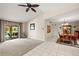 Bright living room with tile and carpet, complemented by sliding glass doors that lead to a screened lanai and pool at 1452 Wassail Ln, Punta Gorda, FL 33983