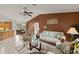 Inviting living room with tile flooring, ceiling fan, and a view of the dining area at 1452 Wassail Ln, Punta Gorda, FL 33983