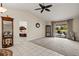 Spacious living room with tile and carpet flooring, opening to the screened patio and pool at 1452 Wassail Ln, Punta Gorda, FL 33983