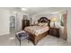Relaxing main bedroom with decorative wood bed frame and neutral toned walls at 1452 Wassail Ln, Punta Gorda, FL 33983