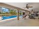 Large covered patio with dining and lounge area overlooking the screened-in pool at 1452 Wassail Ln, Punta Gorda, FL 33983