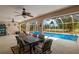 Covered patio with dining set and a view of the screened-in pool at 1452 Wassail Ln, Punta Gorda, FL 33983