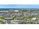 Aerial view showcasing the community's layout amidst lush greenery and blue skies at 1515 Forrest Nelson Blvd # R201, Port Charlotte, FL 33952