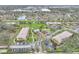 Expansive aerial view of community featuring multiple buildings, pool, and green spaces at 1515 Forrest Nelson Blvd # R201, Port Charlotte, FL 33952