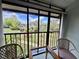Enjoy serene community views from this private balcony with seating area and verdant surroundings at 1515 Forrest Nelson Blvd # R201, Port Charlotte, FL 33952