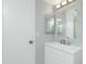 Bathroom showcasing a white vanity, framed mirror, and a glimpse of the shower at 1515 Forrest Nelson Blvd # R201, Port Charlotte, FL 33952