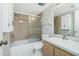 This bathroom offers a shower-tub combo with sliding glass doors and ample storage space at 1515 Forrest Nelson Blvd # R201, Port Charlotte, FL 33952