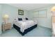 Comfortable bedroom featuring a decorative quilt, a window, and side tables at 1515 Forrest Nelson Blvd # R201, Port Charlotte, FL 33952