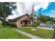 Charming clubhouse featuring a manicured lawn and decorative landscaping, creating a welcoming environment at 1515 Forrest Nelson Blvd # R201, Port Charlotte, FL 33952
