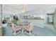 Open dining area with glass table, mirrored wall, and bar counter leading to the kitchen at 1515 Forrest Nelson Blvd # R201, Port Charlotte, FL 33952