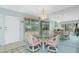 Bright dining area featuring a glass table, chandelier, and mirrored wall, creating a spacious feel at 1515 Forrest Nelson Blvd # R201, Port Charlotte, FL 33952