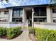 Condo exterior showing the units above on the second floor with screened balconies and stairs in the center at 1515 Forrest Nelson Blvd # R201, Port Charlotte, FL 33952
