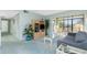 Living room with a glass table and chairs, and a TV set in the background at 1515 Forrest Nelson Blvd # R201, Port Charlotte, FL 33952