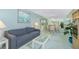 Living and dining room with a grey sofa, glass table, and dining set with pastel chairs at 1515 Forrest Nelson Blvd # R201, Port Charlotte, FL 33952