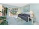 Living room with sofa, sitting area, and light blue walls with wall art and potted plants at 1515 Forrest Nelson Blvd # R201, Port Charlotte, FL 33952