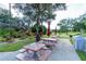 Community picnic area with multiple tables and benches with beautiful trees and landscaping at 1515 Forrest Nelson Blvd # R201, Port Charlotte, FL 33952