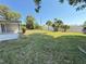 Large backyard with tropical palm trees and privacy fence at 1625 Meadow Lark Ln, Englewood, FL 34224