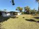 View of home from expansive grassy backyard at 1625 Meadow Lark Ln, Englewood, FL 34224