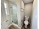 Beautiful bathroom features a glass enclosed shower with gray and white tiling, and wood look flooring at 1625 Meadow Lark Ln, Englewood, FL 34224