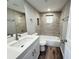 Bathroom featuring updated tile, modern fixtures, and a clean, bright aesthetic at 1625 Meadow Lark Ln, Englewood, FL 34224