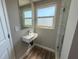This bathroom boasts a modern sink, wood look flooring, and a window for natural lighting at 1625 Meadow Lark Ln, Englewood, FL 34224