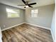 Comfortable bedroom featuring modern flooring, neutral paint and two windows offering natural light at 1625 Meadow Lark Ln, Englewood, FL 34224