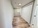 Hallway featuring new floors, neutral paint, and closet space at 1625 Meadow Lark Ln, Englewood, FL 34224