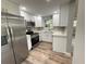 Updated kitchen with stainless steel appliances, white cabinets, and modern countertops at 1625 Meadow Lark Ln, Englewood, FL 34224