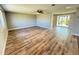 Open living room featuring modern flooring, a ceiling fan, and sliding glass doors to the outdoors at 1625 Meadow Lark Ln, Englewood, FL 34224