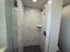 This bathroom shower has gray flooring and bright white tiling at 1625 Meadow Lark Ln, Englewood, FL 34224