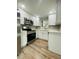 Bright kitchen featuring stainless steel appliances, white cabinetry, and modern countertops at 1625 Meadow Lark Ln, Englewood, FL 34224