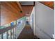 Hallway with wood-paneled ceiling and railing, offering a unique architectural detail at 18419 Meyer Ave, Port Charlotte, FL 33948