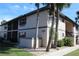 Condo building with a well-maintained exterior and tropical landscaping at 19505 Quesada Ave # Mm202, Port Charlotte, FL 33948