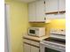 Kitchen appliances, including a microwave and range, with white cabinets at 19505 Quesada Ave # Mm202, Port Charlotte, FL 33948