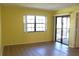 Living room featuring laminate floors, large window, and sliding door access to the patio at 19505 Quesada Ave # Mm202, Port Charlotte, FL 33948