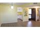 Open-concept living area with laminate floors and access to the kitchen at 19505 Quesada Ave # Mm202, Port Charlotte, FL 33948