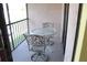 Cozy screened patio with metal table and chairs, perfect for enjoying the outdoors at 19505 Quesada Ave # Mm202, Port Charlotte, FL 33948