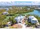 Aerial view of waterfront homes along river with lush surrounding landscaping and homes nearby at 20 Palm Dr, Placida, FL 33946