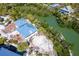 High angle view of a waterfront home featuring a dock and lush vegetation and turquoise waterways at 20 Palm Dr, Placida, FL 33946