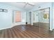 Calming bedroom with hardwood floors, windows, and a closet with mirrored doors reflecting the room at 20 Palm Dr, Placida, FL 33946